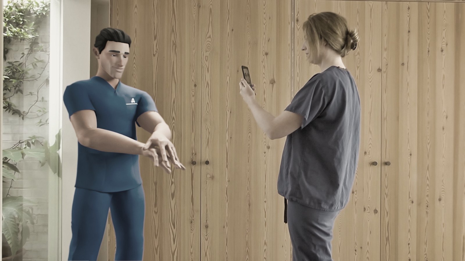 A health worker points a phone at an augmented reality clinician demonstrating hand hygiene